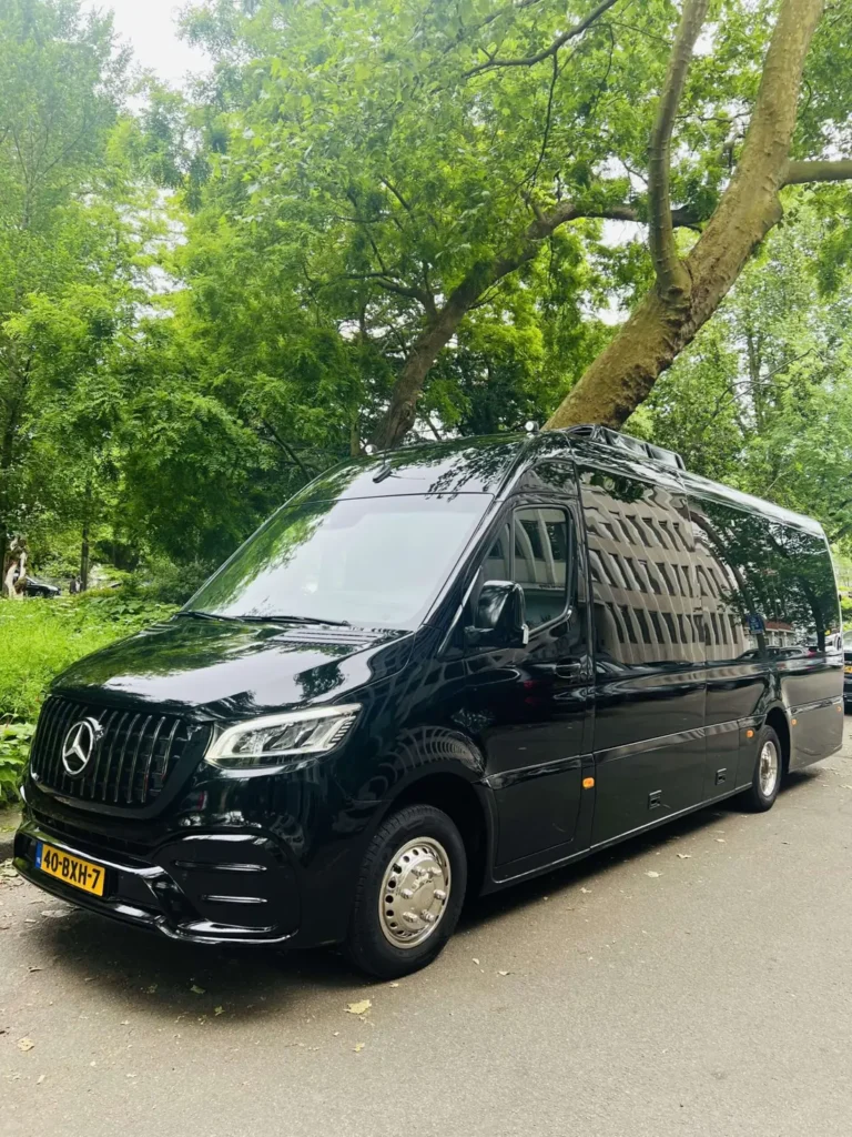 Black Mercedes Sprinter of Amsterdam Luxury Travel on a tree-lined street in Amsterdam
